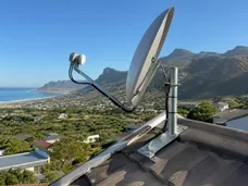 Satellite dish aligned against the Noordhoek mountain skyline