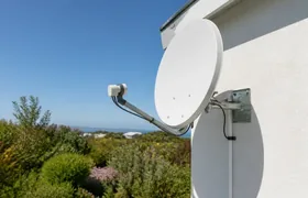 Satellite dish being mounted on a galvanised coastal-rated bracket